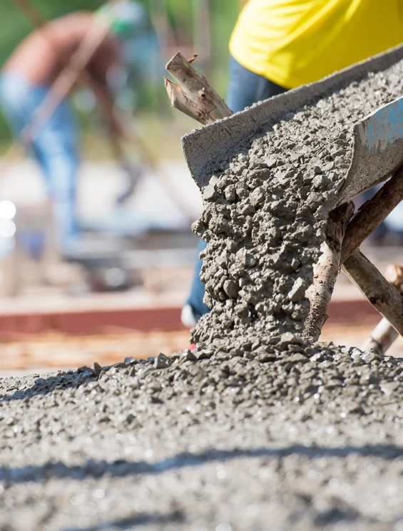 Fresh cement being poured for professional flooring installation and repair services