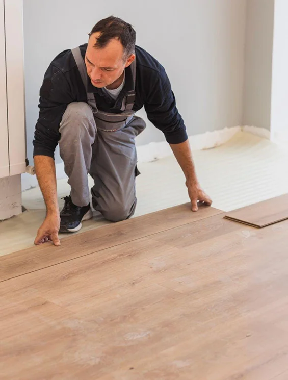 Contractor installing new laminate flooring for home improvement