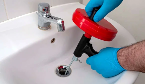 Professional drain cleaning service in Manchester, MA, unclogging sink to effectively clear blockages.