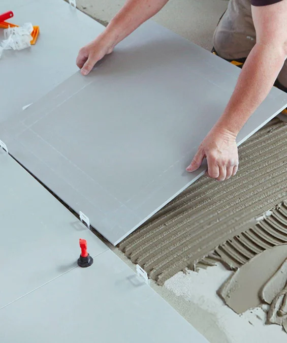 Tile being installed by professional flooring installer