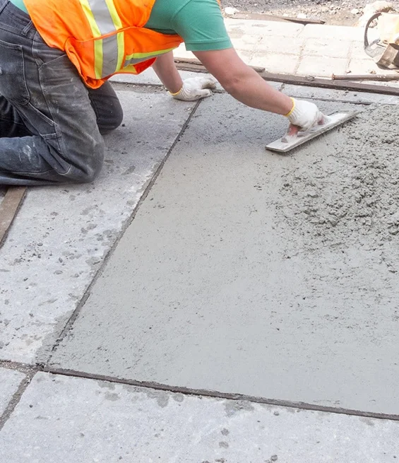 Professional concrete contractor smoothing fresh concrete for a durable surface
