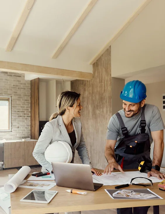 Handyman discussing remodeling plans with client, showcasing affordable home remodeling services