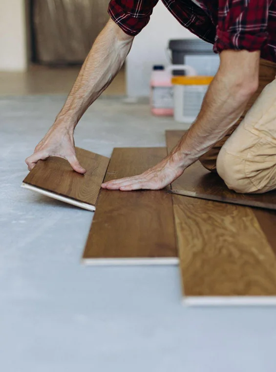 Laying laminate flooring during professional flooring installation
