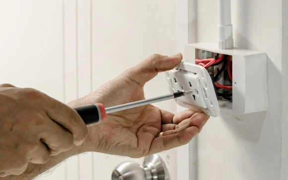 Electrician working on electrical wiring in North Andover, MA, ensuring safe and efficient connections.