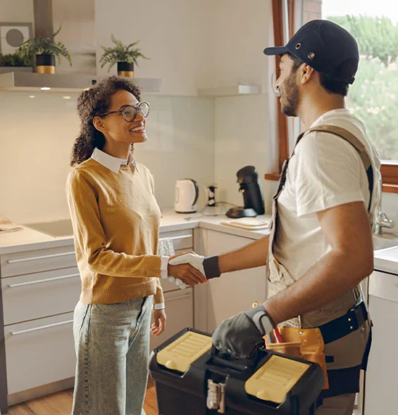 Handyman consulting with a client in a kitchen, representing reliable handyman services