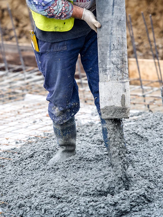 Worker using a concrete pump for a construction project