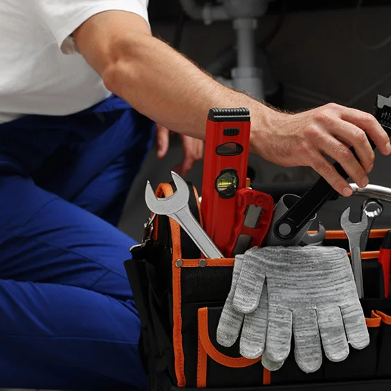 Handyman's tool bag and gloves representing handyman services in Boston