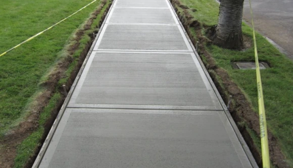 Newly constructed concrete walkway in Wilmington, MA, providing a safe and stylish path through the garden.